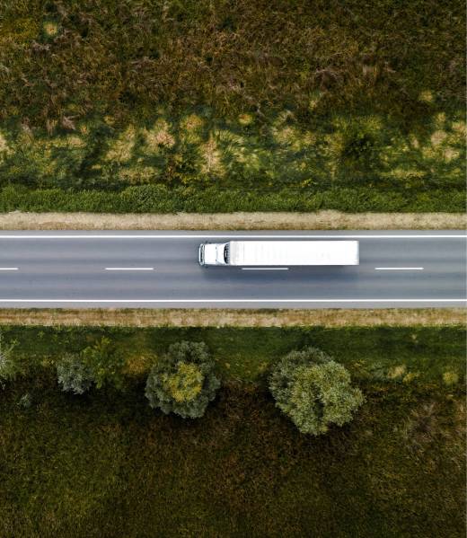 Large freight transporter semi-truck on the road, aerial view